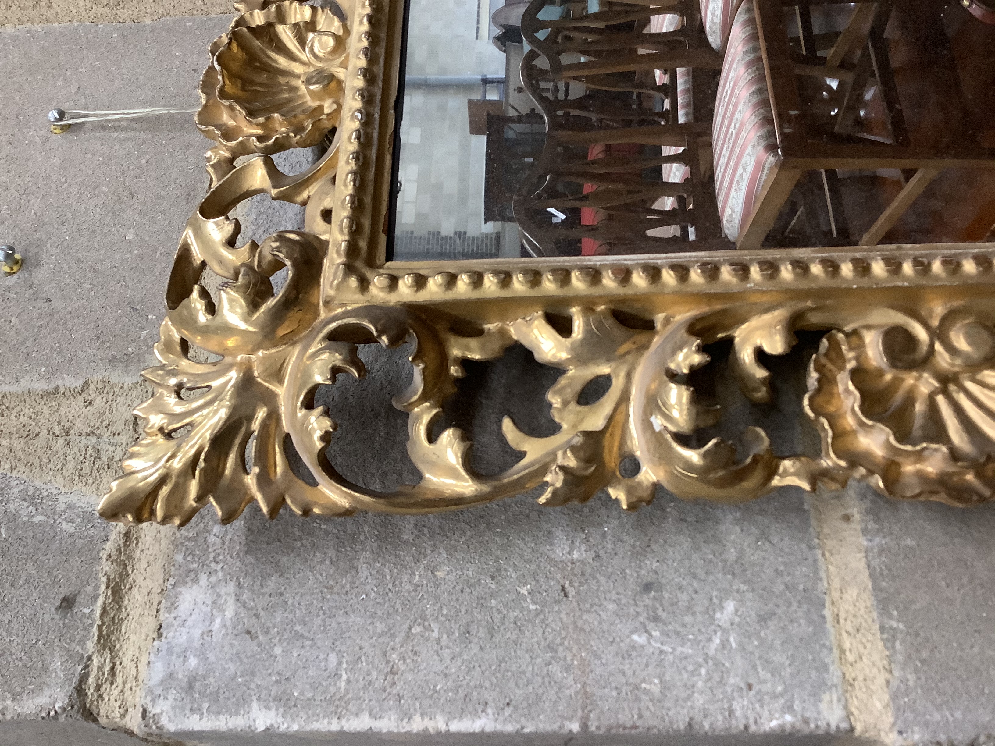 A Venetian foliate carved and pierced giltwood wall mirror, width 36cm, height 50cm 51.5 x 36.5cm